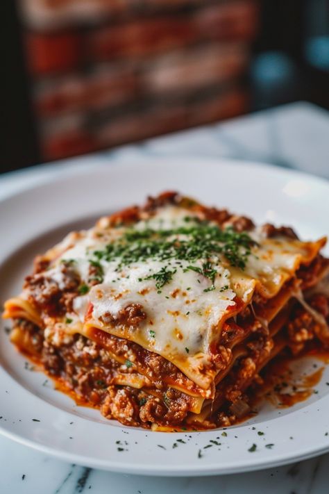 Indulge in a comforting homemade lasagna tonight with this delicious recipe! Layers of tender pasta, rich meat sauce, and creamy cheese make this classic dish an irresistible crowd-pleaser. Whether you're cooking for the family or hosting friends, lasagna is always a hit. Follow this simple recipe to create a mouthwatering lasagna that will have everyone asking for seconds. Enjoy the savory flavors and hearty goodness of lasagna - perfect for any occasion! Delicious Lasagna Recipe, Summer Lasagna Recipe, Lasagna Dinner Aesthetic, Lasagna And Salad, Meaty Lasagna Recipe, Lasange Recipe Classic, Fancy Food Ideas, Dinner Recipes Friends, Lasange Recipe Homemade Lasagna