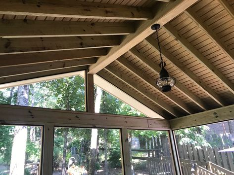 The aesthetics of pressure-treated pine throughout this screened porch are anything but boring. From the diagonal orientation of the floorboards to the exposed rafters, the porch delivers a thoroughly rustic vibe. We used PT pine for the rafters, wall posts, and rails in addition to the flooring. Rambler Porch Addition, Screened In Porch Pitched Roof, Exposed Rafters Ceiling Porch, 40 Decorations, Covered Patio Exposed Rafters, Gabled Roof Screened Porch, Gabled Screen Porch, Uncovered Porch, Gable Roof Porch