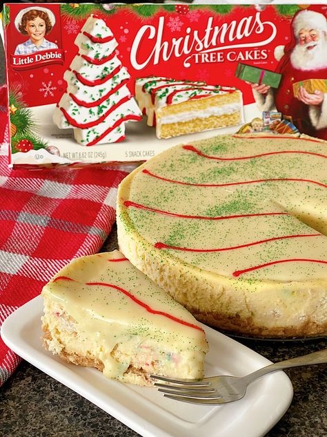 Indulge in the ultimate holiday dessert with the Little Debbie Christmas Tree Cake Cheesecake. A luscious Golden Oreo crust serves as the perfect foundation for this decadent delight. Nestled within is a layer of iconic Little Debbie Christmas Tree Cakes, adding a whimsical touch and nostalgic flavor. The creamy homemade cheesecake filling provides a velvety texture and rich taste that perfectly complements the cake layer. No Bake Christmas Tree Cheesecake, Little Debbie Cheesecake Christmas Tree, Little Debbie Christmas Cheesecake, Little Debbie Cheesecake, Christmas Tree Cake Cheesecake, Homemade Cheesecake Filling, Little Debbie Christmas Tree Cheesecake, Christmas Tree Cheesecake, Golden Oreo Crust