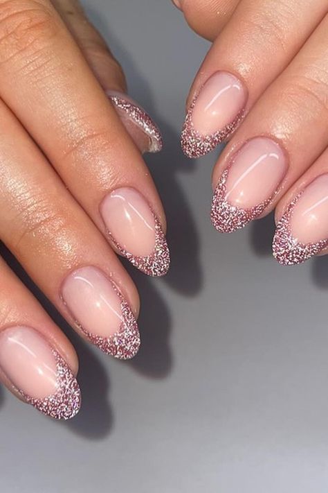 Almond-shaped nails with a sheer pink base exude elegance. The tips are dipped in fine silver glitter, creating a sophisticated French manicure with a sparkling twist. This timeless yet trendy style adds a touch of glamour to any look. Simply chic! ✨  // Photo Credit: Instagram @angelsbyannabel French Manicure Designs With Glitter, Glitter Nail French, Almond Shape Glitter French Tip, Almond Nail Inspo Glitter, Sparkling French Manicure, Almond French Nails With Glitter, Almond Nails French Tip With Glitter, Light Pink New Years Nails, Pink Sparkly French Tip Nails Almond