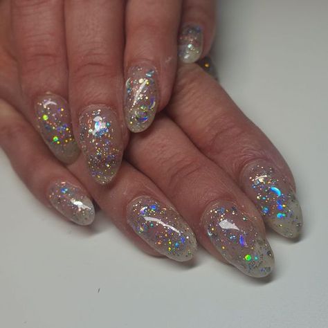 Bring It On! Here's 50 Glamorous New Year's Eve Nail Designs for 2025 21 Silver Galaxy Nails, Iridescent Star Nails, Holographic Star Nails, Clear Star Nails, Nails W Stars, Star Themed Nails, Moon And Star Nail Designs, Silver Holographic Nails, Star Glitter Nails