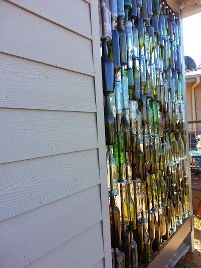 A Husband And Wife Want Privacy On Their Porch, But Instead Of Curtains...THIS Is Incredible! Rustic Chic Wall Decor, Sea Glass Window Art, Wine Bottle Wall, Bottle Projects, Wine Bottle Ideas, Bottle Trees, Empty Wine Bottles, Wine Bottle Art, Bottle Garden