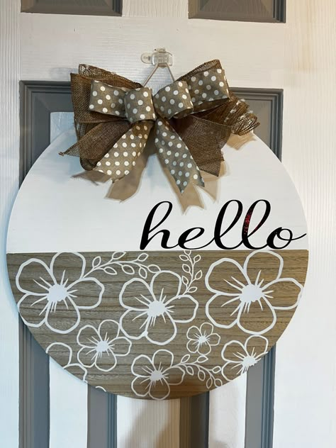 This is an 18" wood door/wall hanger, the white is hand painted. I use Oracal 651 outdoor, permanent vinyl. The bow is a mixture of ribbon and deco mesh. I add bumpers on the back to protect your door/wall. Wooden Circle Crafts Ideas, Spring Door Rounds, Door Hangers Wooden Diy, Circle Door Hangers Wooden Diy, Circle Door Hangers, Wooden Circle Crafts, Wood Sign Ideas, Circle Signs, Wood Yard Art