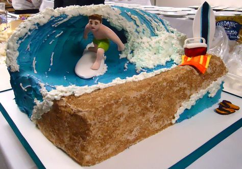 Surfing - This surfing cake was created with a rice crispy wave, modeling chocolate surfer dude, complete with and beach towel, flip flops and cooler for a cold one, all mad of sugar paste. The cake was covered in buttercream then airbrushed, and finished off with cane sugar for sand. Surfing Cakes, Surfing Cake, Surfboard Cake, Surfer Cake, Surf Cake, Wave Cake, Sea Cake, Surf Party, Sea Cakes