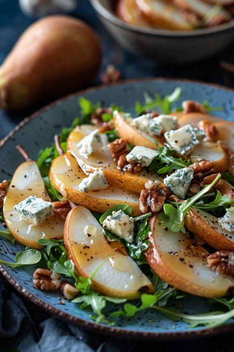 Sliced pear salad with arugula, blue cheese, and walnuts on a blue plate. Baked Pear Salad, Pears And Gorgonzola, Pear Recipes Salad, Pear Cheese Salad, Salad With Pears And Gorgonzola, Gorgonzola Pear Salad, Crisp Salad Recipes, Sweet And Savory Salad, Italian Side Salad Recipes