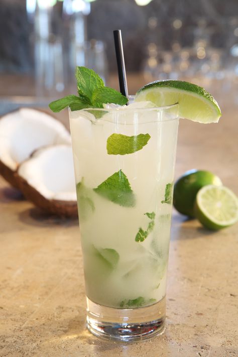 coconut mojito: squeeze of half a lime, 6 mint leaves, 1 oz. vodka, .5 oz. coconut rum, 1 oz. pineapple juice, .25 oz. cream of coconut, splash of soda, sprig of mint and lime wedge for garnish. muddle mint leaves. combine with ice and shake all ingredients, except for soda. pour into iced glass and top with splash of soda. garnish with a mint sprig and lime wedge. Ciroc Coconut, Coconut Vodka, Mojito Ingredients, Mojito Drink, Coconut Mojito, Mojito Recept, Malibu Coconut, Fresh Fruit Recipes, Mojito Recipe