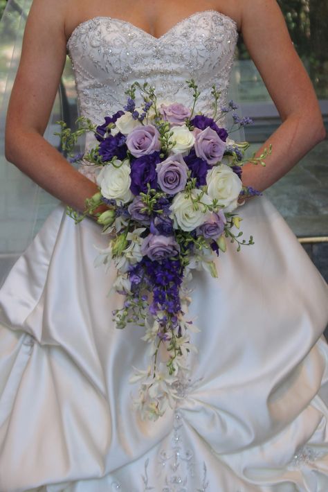 Purple and lavender cascade bouquet | Roses, lisianthus, orchids and larkspur Zen Wedding, Trailing Bouquet, Dark Purple Roses, Wedding Top Table, Purple Bridal Bouquet, Cascading Bouquet, Cascading Wedding Bouquets, Bouquet Roses, Purple Wedding Bouquets