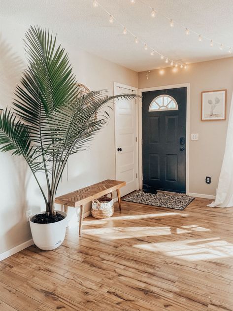 Potted Costco majesty palm plant in entryway next to wood bench Palm Indoor Plant Living Rooms, Home Entrance Plants Outdoor, Floor Plants Bedroom, Indoor Palm Plants Living Rooms, Faux Palm Tree Home Decor, Plants In Entryway, Hallway Plant Ideas, Entryway Plants Indoor, Majesty Palm Indoor