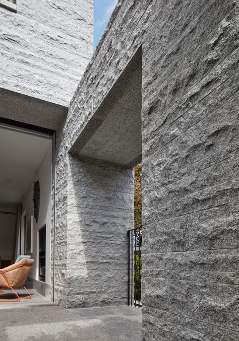 The three-level house is constructed from 260 tonnes of granite. Natural Stone Facade Architecture, Stone Architecture Modern, Granite Wall Design, Granite Stone Texture, Cladding Texture, Outdoor Wall Fountains, Stone Wall Design, Stone Wall Cladding, Stone Facade