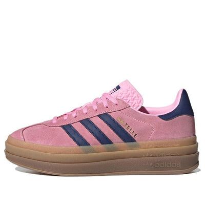 The adidas Gazelle Bold Pink Glow W is a stylish sneaker featuring a vibrant pink suede upper with signature 3-Stripes. The gum outsole adds a touch of retro flair, while the pink laces and metallic "Gazelle" inscription complete the look. This comfortable and fashionable shoe is perfect for adding a pop of color to any outfit. (SNKR/Skate/Low Top/Women's/Non-Slip/Heightening/Wear-resistant) Pink Shoes Platform, Pink And Navy Adidas Gazelle, Shoes For Women Adidas, Blue And Pink Sambas, Gazzels Shoes, Pink And Green Sambas, Adidas Shoes Women Gazelle Outfit, Platform Adidas Gazelle, Gazelle Adidas Shoes