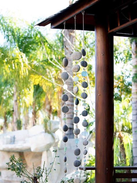 A rain chain can be as simple as just a chain but often they have metal tubes, flowers, or other shapes suspended at intervals down the chain which help to funnel the water as well as looking beautiful. A rain chain is a decorative chain that you can use in place of an unsightly downspout...Read On → Homemade Rain Chain, Diy Indoor Fountain, How To Make A Rain Chain, Japanese Rain Chain, Rain Chain Diy, Rain Chimes, Backyard Vibes, Cross Wreath Diy, Rain Catcher