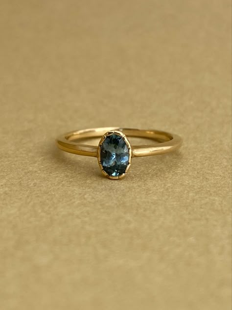 This beautiful, nature-emulating ring features an organic textured bezel-set center teal Montana Sapphire. An exquisite ring for those who appreciate the tranquility of nature, natural beauty, and a sophisticated design aesthetic. The low-profile bezel allows for a multitude of curve, cluster, and v-shaped wedding bands to be comfortably nested. Pretty Wedding Rings, Gold Band Engagement Rings, Montana Sapphire Engagement, Montana Sapphire Engagement Ring, Montana Sapphire Ring, Emerald Ring Vintage, Bezel Engagement Ring, Yellow Jewelry, Engagement Ring Shapes