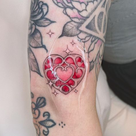 Part 2 of my art trade with @liesbethtatjana ! A lil heart container gapfiller 💖 Done at @leflux.tattoos ✿ follow the rest of the… | Instagram Legend Of Zelda Heart Container Tattoo, 8 Bit Heart Tattoo, Legend Of Zelda Tattoo Twilight Princess, Zelda Heart Container Tattoo, Heart Container Tattoo, The Legend Of Zelda Tattoo Ideas, Zelda Heart Tattoo, Princess Zelda Tattoo, Utena Tattoo