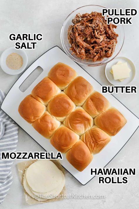 Hungry for something quick and tasty, then try these pulled pork sliders for scrumptious sandwiches with a bold, slow-cooked flavor! Load up some buttery Hawaiian rolls with precooked shredded pork, and melt mozzarella or Havarti on top. Pair with coleslaw for an easy, crowd-pleasing dinner. The best meal idea for on-the-go families. Prep, heat, and serve in under 20 minutes! #theshortcutkitchen #pulledporksliders #pulledporkslidersrecipe #bestpulledporksandwiches French Dip Hawaiian Roll Sliders, Hawaiian Roll Sliders Pulled Pork, Pull Pork Sliders Recipes Hawaiian Rolls, Easy Slider Recipes Hawaiian Rolls, Sandwiches With Hawaiian Rolls, Pulled Pork Hawaiian Rolls Sliders, Mini Pulled Pork Sliders, Pork Sliders Hawaiian Rolls, Pulled Pork Sliders Hawaiian Rolls