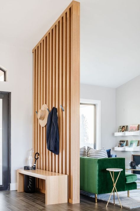 A blend of color and texture adds warmth to your foyer that welcomes you in. Having a bench in your foyer not only makes a stylish design element, but also serves as a functional component for owners and guests.​​​​​​​​ ​​​​​​​​ We anchored the bench with a slatted wood wall to define the entrance and divide the foyer from the living space.​​​​​​​​ ​​​​​​​​ Entryway Divider, Slatted Wood Wall, Living Room Divider, Wood Slat Wall, Living Room Partition, Living Room Partition Design, Room Partition Designs, Divider Wall, Room Partition