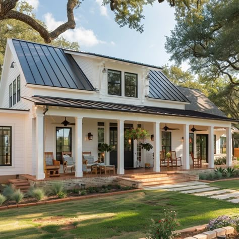 A cozy front porch with wooden columns, Adirondack chairs, and potted plants creates a welcoming entrance Farmhouse Porch Columns, Typical American House, House With Front Porch, Fancy House Design, Big Front Porches, Beautiful Modern Farmhouse, Practical Home Decor, White Modern Farmhouse, Deck Railing Ideas