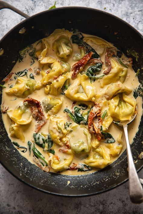 top down of a pan with tuscan tortellini sauce and a spoon Tortellini Sauce Recipes, Tortellini Sauce, Creamy Tuscan Tortellini, Tuscan Tortellini, Cream Sauce Pasta, Spinach Tortellini, Sausage Tortellini, Pasta Meals, Tortellini Recipes