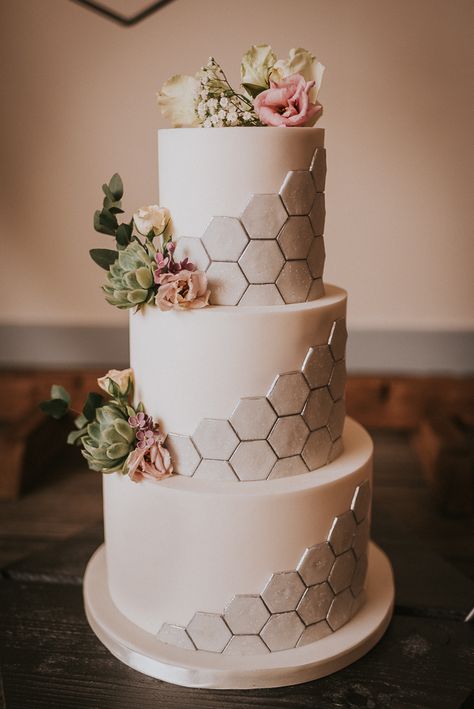 Three Tier White Wedding Cake with Silver Hexagonal Honeycomb Effect | Photographer: Grace Nicole Photography | Styling Direction & Props: The Rustic Wedding Company | Venue: Swallow’s Next Barn | Florist: Lilac & Wild | Cakes: Deliciously Divine Cake Design | Props: Bramble Sky | Stationery: Jenna Claire Stationery | Makeup: Louise A’Ness Makeup Artist | Hair: Occassion Hair by Helen | Model: Ioana Matache | Wedding Dresses: Dress Me Pretty Bridal Room Hexagon Wedding Cake, Geometric Cake, Hexagon Wedding, Wedding Cake Prices, 3 Tier Wedding Cakes, Romantic Wedding Cake, Engagement Cakes, White Wedding Cake, Wedding Cake Inspiration