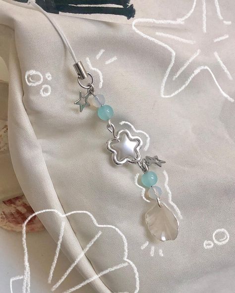 some more pics of the new keychain 🐚 - - #smallbusiness #beadedjewelry #beadedkeychain #beadedphonecharm #aestheticjewelry #seacore #mermaidcore Mermaidcore Aesthetic, Keychain Blue, Kawaii Accessories, Sea Star, Phone Strap, Charm Keychain, Beaded Keychains, Blue Pearl, Phone Charm