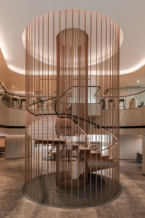 The staircase by Ministry of Design inside YTL Headquarters in Kuala Lumpur Brown Leather Chairs, Shared Office Space, Timber Table, Construction Firm, Shared Office, Booth Seating, Spiral Stairs, Spiral Staircase, 3d Warehouse