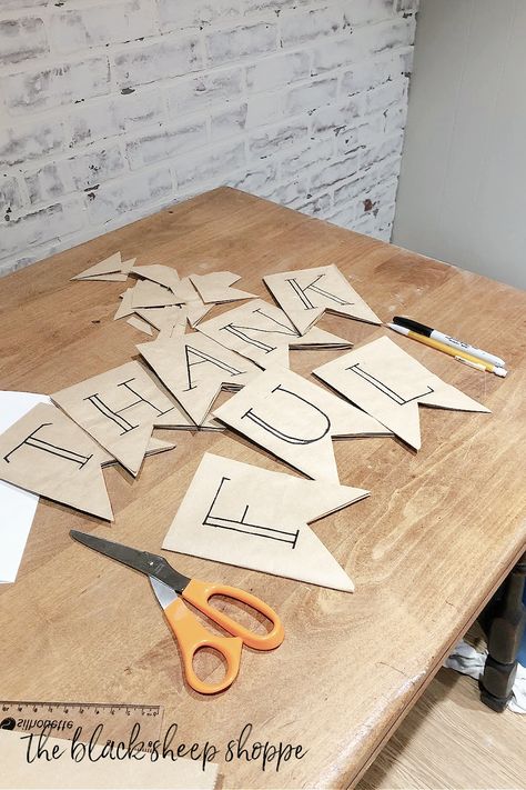 Paper lunch bags cut into flag shapes. Letters written with a sharpie marker spell THANKFUL. Butcher Paper Party Decor, Diy Pennant Banner Paper, Diy Triangle Banner, Diy Banner Letters, Butcher Paper Sign, Diy Bunting Banner, Diy Pennant Banner, Homemade Banners, Granny Magic