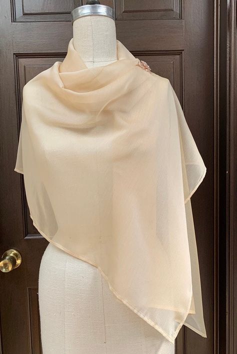 "Very light and airy shawl made out of iridescent chiffon. Easily draped and fixed with broach or tied at back to transform into shrug.  Great shear cover up for top of your body.  Poly chiffon prevent from wrinkles, easy to take care.  Size of shawl does not overpowering with lots of fabric when wearing  Size around 22\"x 60\" Fabric  Champagne Iridescent Chiffon  You have choices of broach: 1. Pearl flower 2. Pink Gold ornament" Shawl For Dress, Shawl Styling, Scarf Outfits, Blush Shoes, Shawl Design, Scarf Coverup, Ivory Wedding Gown, Shawl Style, Accessories Inspiration