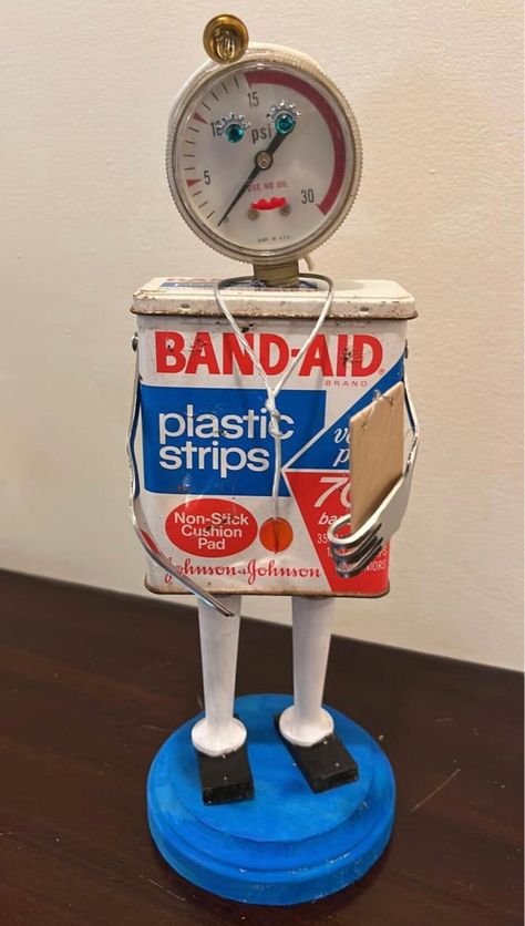 "These doctors are on duty! Made from vintage bandaid tins and other found objects, these little guys are sure to bring a smile! Each holds a little clipboard chart in his forked hand, has a tiny stethoscope around his neck and wears a sweet silver heart. Bandaid also has a tiny \"headlamp\". Great gift idea for your favorite physician! Choose from BandAid (stands approximately 10.5\" high) or Curad (stands 9\" high). Both are on a 4\" round base." Found Objects Sculpture, Tin Can Robots, Found Object Sculpture, Repurposed Junk, Object Sculpture, Diy Recycled Projects, Assemblage Art Dolls, Tin Can Art, Recycled Art Projects