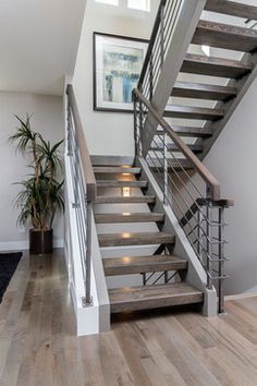 Grey hardwood floors with open staircase & steel railings Grey Hardwood Floors, Stairs Lighting, درج السلم, Grey Hardwood, Open Stairs, Contemporary Stairs, House Staircase, Escalier Design, Staircase Ideas