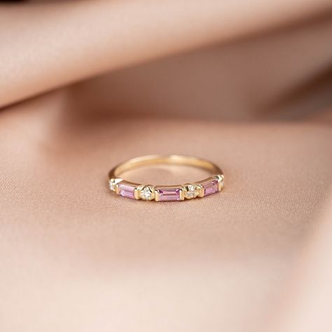 An elegant pink sapphire ring in 14K solid gold. A unique half eternity wedding band for women, ideal for stacking with engagement ring. The best anniversary gift for her! 100% handcrafted with love! PRODUCT DETAILS * Metal: 14K solid gold, 14K white gold * Gemstone: 3 Natural Sapphires, 4 x 2mm, Baguette cut, 4 Diamonds 1.5mm, Brilliant cut * Sapphires' Weight: 0.245ct total HOW TO ORDER Choose from the drop down menus the available option (Ring size) and leave us a note for any special require Pink Sapphire Eternity Band, Pink Stone Wedding Band, Pink Diamond Wedding Band, Pink Sapphire Solitaire Ring, Pink Sapphire Rings, Rose Gold Wedding Band For Women, Pink Wedding Band, Pink Sapphire Wedding Ring, Pink Sapphire Wedding Band