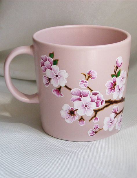 Hand painted ceramic coffee mug with elegant cherry blossom design. Can be personalized. Be sure it makes a unique gift for mom, aunt, sister, grandma, daughter at birthday, Mother's day, Christmas and any other occasion. Cherry Blossom Ceramic Painting, Pottery Painting Coffee & Tea Cups, Creative Mug Designs, Mug Painting Designs, Mug Designs Painted, Mug Art Paint, Hand Painted Mugs Ideas, Cherry Blossom Mug, Ceramic Cafe