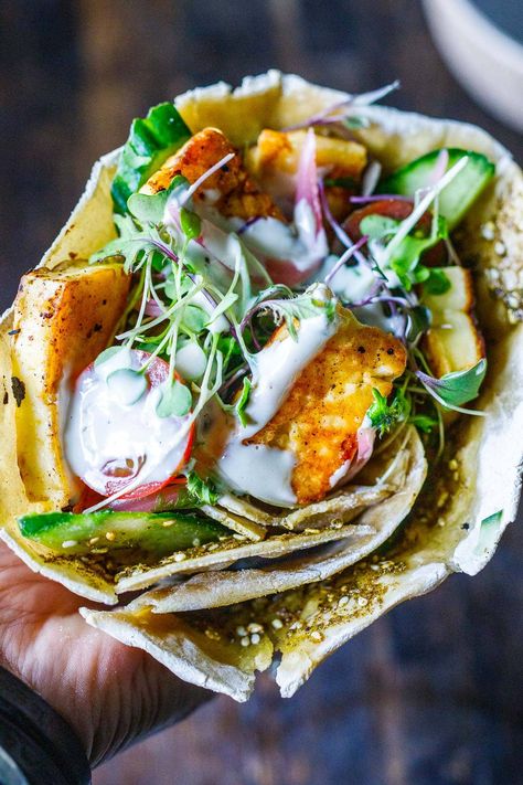 A delicious Halloumi Wrap recipe made with flavorful manoushe, pan-seared halloumi, fresh veggies, and a creamy tahini yogurt sauce. Haloumi Wrap Recipes, Seared Halloumi, Halloumi Wrap, Pesto Wrap, Haloumi Recipes, Feasting At Home, Hummus Wrap, Halloumi Cheese, Spinach Wraps