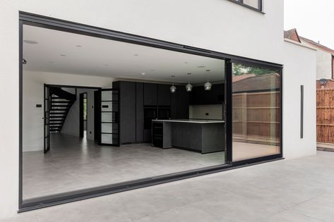 Not only do sliding doors allow the light to fill your home, they offer best views of your garden all year long 🌿☀️🌷

These images are from one of our latest projects in St. Albans, where our client chose the ever popular @sunflexuk sliding doors for their rear extension. With 30mm sightlines, the slim frames were finished in black to add to the contemporary style both inside and out. With a flush threshold with the patio, they allow a seamless flow with the outdoors which we just love! Black Sliding Doors Patio, Timber Front Door, Sliding Doors Internal, Internal Sliding Doors, Rear Extension, Upvc Windows, Sliding Patio Doors, Pivot Doors, St Albans