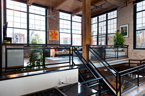 The view of the upper living area, which is actually street level. Timber Living Room, Industrial Jungle, Industrial Penthouse, Loft Apartment Industrial, West Loop Chicago, Chicago Lofts, Nyc Dream, Loft Apartment Decorating, Warm Industrial