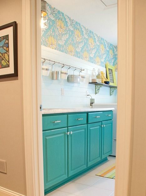 The Dash & Albert rug was the jumping off point, but the Amy Butler wallpaper brought it home for me! The cabinets I painted with a custom mix of Annie Sloan Chalk Paint (50/50 Provence & Florence).” Teal Laundry Room, Teal Bathroom Ideas, Laundry Room Colors, White Laundry Rooms, Teal Bathroom, Laundry Room Wallpaper, Best Kitchen Cabinets, Room Wall Painting, Laundry Room Cabinets