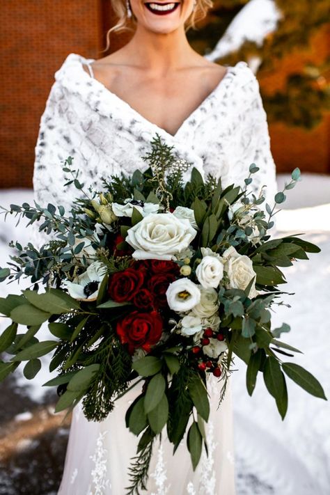 Stunning bridal floral bouquet with red and white roses and greenery. Bridal Bouquet Red And White Roses, Winter Bouquet Aesthetic, Bridal Bouquet Christmas Wedding, Winter Rose Bouquet, Berry Winter Wedding, December Wedding Bouquets Brides, Christmas Wedding Picture Ideas, Wedding Bouquets Red And White, Rustic Winter Wedding Bouquet