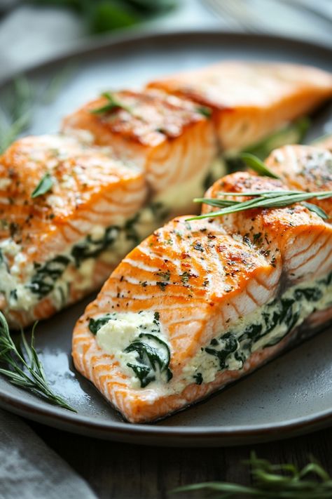 Grilled salmon fillets stuffed with spinach and creamy cheese on a plate. Salmon And Cream Cheese Recipes, Spinach Salmon, Salmon Fillet, Stuff Salmon Recipes, Salmon Stuffed With Spinach, Blackened Salmon Stuffed With Spinach And Parmesan Cheese, Spinach Stuffed Salmon, Spinach Stuffed Salmon Baked, Creamy Spinach Salmon