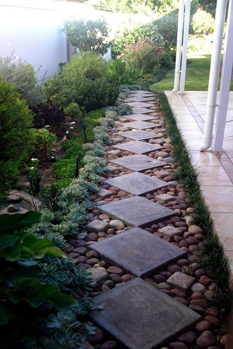 This square shaped concrete pavers on the garden stones add dignity and an easy way to prevent the pathway from getting wet. This space is ideal to have outdoor gatherings.#walkwaydesign   #walkwayidea  #walkwayideas  #gardenwalkway Side Yard Landscaping, Gravel Garden, Garden Walkway, Rock Garden Landscaping, Stone Path, Urban Gardening, Garden Yard Ideas, Garden Pathway, Landscaping With Rocks