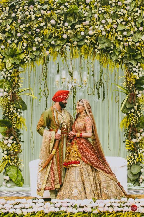 Photo of Coordinated bride and groom on stage decked up with unique floral arrangement Sikh Wedding Photography, Anand Karaj, Sikh Bride, Bride Photos Poses, Unique Floral Arrangements, South Indian Weddings, Bridal Pictures, Wedding Planning Websites, Punjabi Wedding