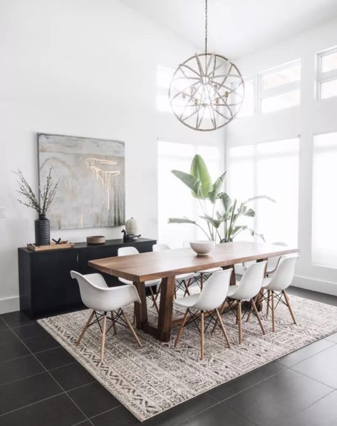 Complete your kitchen with a stunning kitchen table that's set for success. We love how this wooden table is paired with white chairs and a decorative rug underneath for visual appeal. Dining Room Lamps, Modern Apartment Decor, Rustic Dining Room, Dining Room Inspiration, Farmhouse Dining, Rustic Dining, Modern Dining Room, Design Living, Dining Room Lighting