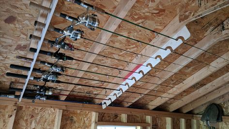 Ceiling Fishing Rod Storage, Garage Fishing Rod Storage, Fishing Rod Holders For Garage, Fishing Pole Storage Diy, Hunting Storage Ideas, Fishing Rod Storage Diy, Hunting Storage Room, Fishing Organization Ideas, Fishing Shed