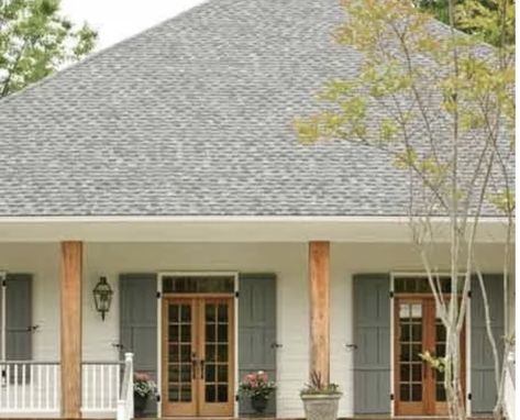 Brick Southern Home Exterior, White House With Natural Wood Shutters, Olive Green And Cream House Exterior, White House With Stained Shutters, Covered Porch Paint Colors, Exterior Oval Window, White And Green Home Exterior, Trendy Shutter Colors, White Cottage With Shutters