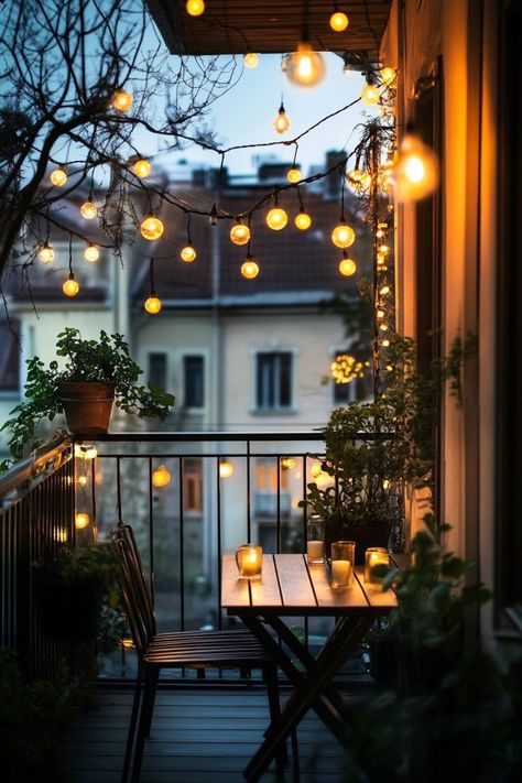 Transform your balcony into a magical oasis with string lights draped around the railings or overhead. Add cozy seating with soft cushions, throw blankets, and a small table for evening relaxation. The twinkling lights will create a warm and inviting ambiance for your outdoor retreat. 🌟🌿 String Lights Outdoor Balcony, Apartment Balcony Lights, Bistro Balcony, Veranda Cafe, Evening Relaxation, Balcony Lighting, House Balcony Design, Home Balcony, Cozy Seating