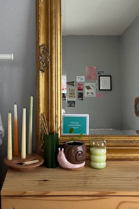 vintage dresser look. urban outfitters teracotta taper candle holder & green essential oil diffuser & light green textured candle, anthropology gold mirror, antique snail potter with chinese money tree house plant. aesthetic, trendy idea inspo vibe for apartment, dorm, bedroom Gold Mirror Dresser, House Plant Aesthetic, Chinese Money Tree, Essential Oil Holder, Apartment Dorm, Mirror Antique, Dorm Inspo, Taper Candle Holder, Vintage Dresser