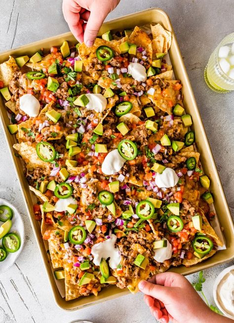 Make the best loaded nachos with this easy recipe. Tortilla chips are topped with a ground turkey refried bean mixture, cheese, tomatoes, avocado and jalapeños for the perfect appetizer or game day snack! Recipe Tortilla, Refried Bean, Loaded Nachos, Game Day Snacks, Perfect Appetizers, Party Food Appetizers, Refried Beans, Ground Turkey, Tortilla Chips