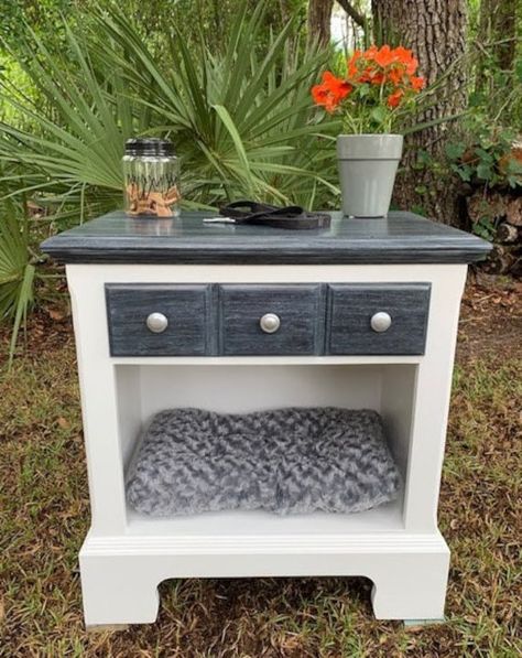 This oak table has been made into a bed for your small pet with a drawer to hold supplies or toys.  It can also be used as an end table, side table or nightstand.  The new pet bed and drawer mat are included, however, the other items in the photo are not.  The base has been hand-painted white while the drawer front and top were stained black, white-washed and sealed.    Approximate measurements are as follows:   Table - 25 3/4" wide x 28" tall x 16" deep. Pet sleep area - 22 1/2" wide x 12 1/4" Cat Bed End Table, Night Stand Dog Bed, Dog Bed Side Table Diy, Dog Bed Furniture End Tables, Dog Bed Night Stand, End Table Pet Bed, End Table Dog Bed, Cats Room, Nyc Room