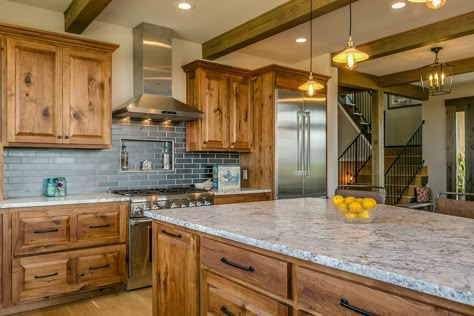 Rustic kitchen with exposed beams, knotty wood cabinets, and blue subway tile backsplash Blue Subway Tile Backsplash, Warm Wood Kitchen Cabinets, Warm Wood Kitchen, Alder Kitchen Cabinets, Hickory Kitchen Cabinets, Hickory Kitchen, Blue Subway Tile, Kitchen Cabinet Inspiration, Cabin Remodel