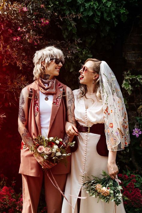 Couple in tanned waistcoat with embroidered flowers and button detail sleeveless wedding dress Masculine Wedding Dresses, Masc Fem Wedding, Masculine Wedding Outfit, Transmasc Wedding Outfit, Unconventional Wedding Outfit, Queer Wedding Attire, Nontraditional Wedding Outfit, Queer Wedding Dress, Non Traditional Wedding Attire