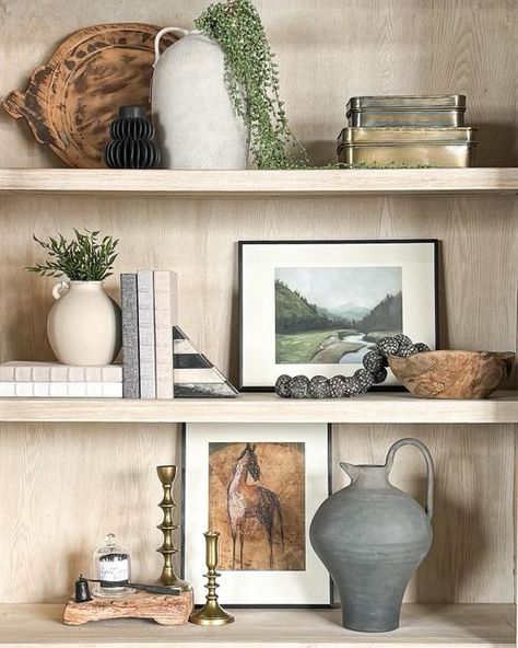 Dwell Home Co. (Home decor shop Eagle, ID) on Instagram: "Ever find yourself staring at your shelf decor, contemplating a change but unsure where to start? 🤔 With so many built-in shelves in newer homes, shelf styling can feel overwhelming. We're here to help and offer advice for showcasing your existing treasures with Dwell pieces. 💬 DM us or call 208-869-2679 to schedule your 2-hour in-home styling appointment (complimentary with a minimum purchase of $750). #shelfstyling #builtinshelves #sh Display Shelf Decor, Ancestral Wall, Natural Bedrooms, Built In Bookshelves Decor, Shelf Styling Bedroom, Open Shelf Decor, Built In Shelf Decor, Styling Built In Shelves, Display Shelves Decor