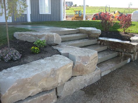 Armor Stone | BAF Landscaping & Contracting Slopped Landscape, Rock Wall Landscape, Natural Stone Retaining Wall, Backyard Retaining Walls, Lake Landscaping, Rock Retaining Wall, Terraced Garden, Landscape Stairs, Rock Walls