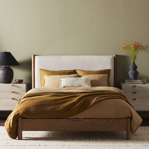 Rounded, chunky dowel legs in an amber oak finish frame the neutral, linen-like upholstered headboard of this bed frame. King Platform Bed, Queen Platform Bed, Adjustable Mattress, Beds & Bed Frames, Four Hands, Bedroom Collection, Upholstered Platform Bed, Oak Veneer, Upholstered Headboard